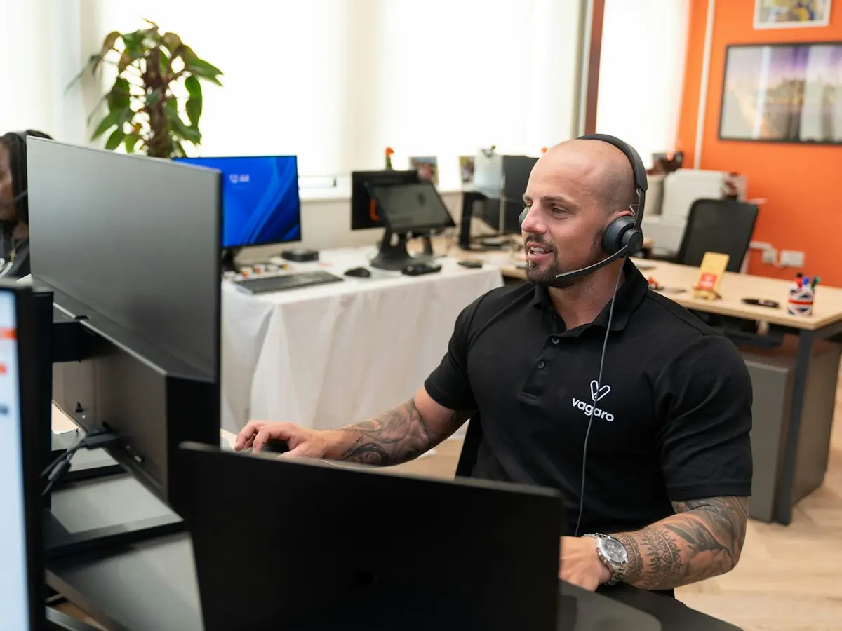 A friendly call support professional wearing a headset at work.