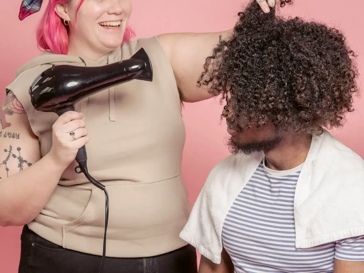 A stylist helping a customer in a bright salon.